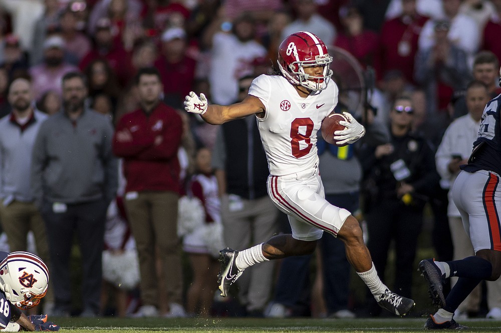Alabama wide receiver John Metchie III (8) gets loose on a pass reception during the first half of an NCAA college football game against Auburn, Saturday, Nov. 27, 2021, in Auburn, Ala. (AP Photo/Vasha Hunt)
