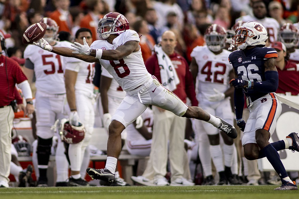 Alabama wide receiver John Metchie III (8) can&#x27;t make a fingertip catch after getting ahead of Auburn cornerback Jaylin Simpson (36) during the first half of an NCAA college football game, Saturday, Nov. 27, 2021, in Auburn, Ala. (AP Photo/Vasha Hunt)