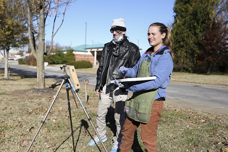 Artist Kate Fleming (right) paints as Steven &quot;School&quot; (left) observes her painting Nov. 18 at the parking lot of the Walmart Supercenter in Rogers. Artists Kate Fleming and Tom Woodruff of The 50 States Project finished their two-year-long tour of all 50 states in Northwest Arkansas. Check out nwaonline.com/211129Daily/ for today's photo gallery. 
(NWA Democrat-Gazette/Charlie Kaijo)