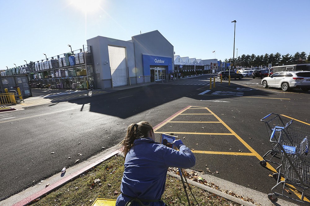 Artist Kate Fleming paints Nov. 18 at the parking lot of the Walmart Supercenter in Rogers. Artists Kate Fleming and Tom Woodruff of The 50 States Project finished their two-year-long tour of all 50 states in Northwest Arkansas. Check out nwaonline.com/211129Daily/ for today's photo gallery.
(NWA Democrat-Gazette/Charlie Kaijo)
