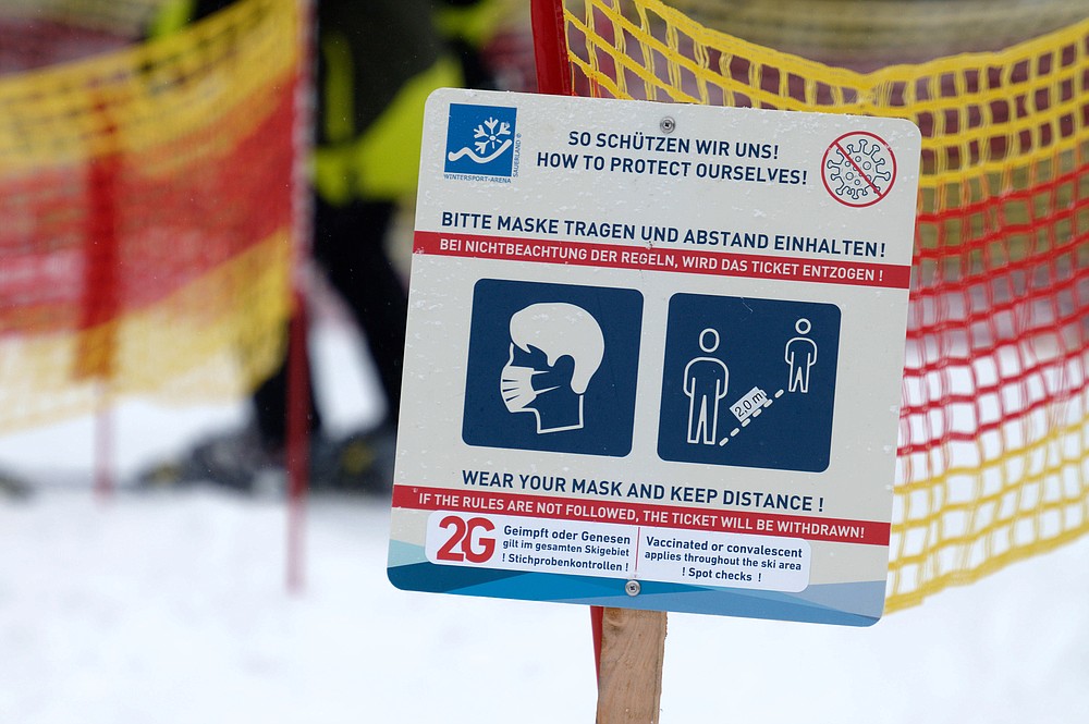 A sign indicating COVID-19 restrictions is seen at the Rauher Busch ski slope in Winterberg, Germany, Saturday, Nov. 27, 2021.  (Henning Kaiser/dpa via AP)