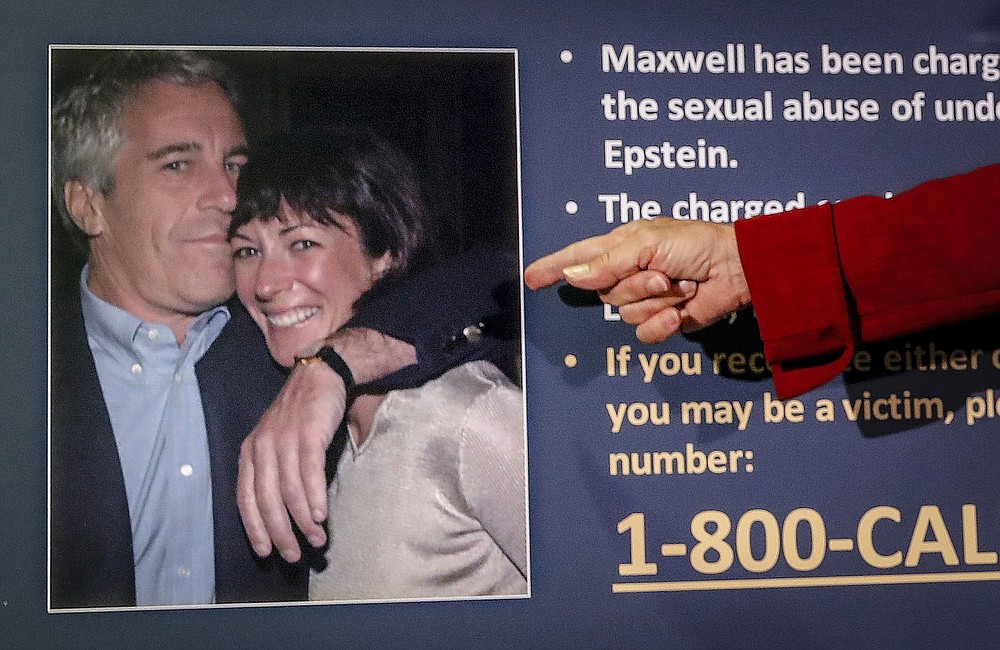 FILE — Audrey Strauss, acting U.S. attorney for the Southern District of New York, points to a photo of Jeffrey Epstein and Ghislaine Maxwell during a news conference in New York, July 2, 2020. Maxwell spent the first half of her life with her father, a rags-to-riches billionaire who looted his companies&#x27; pension funds before dying a mysterious death. She spent the second with another tycoon, Jeffrey Epstein, who died while charged with sexually abusing teenage girls. Now, after a life of both scandal and luxury, Maxwell&#x27;s next act will be decided by a U.S. trial. (AP Photo/John Minchillo, File)