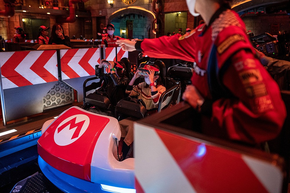 Guests on a &amp;#x201c;Mario Kart&amp;quot;-inspired ride at Universal Studios Japan, which utilizes augmented reality techniques, in Osaka on March 17, 2021. (Philip Fong/AFP/Getty Images/TNS)