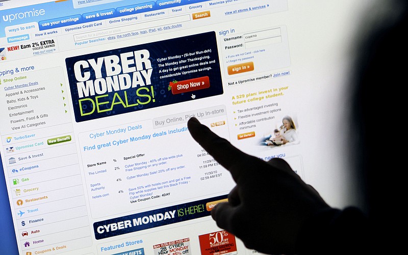 FILE - In this Nov. 29, 2010 file photo, a consumer looks at Cyber Monday sales on her computer at her home in Palo Alto, Calif. Consumers are expected to spend between $10.2 billion and $11.3 billion on Monday, Nov. 29, 2021 making it once again the biggest online shopping day of the year, according to Adobe Digital Economy Index. (AP Photo/Paul Sakuma, File)