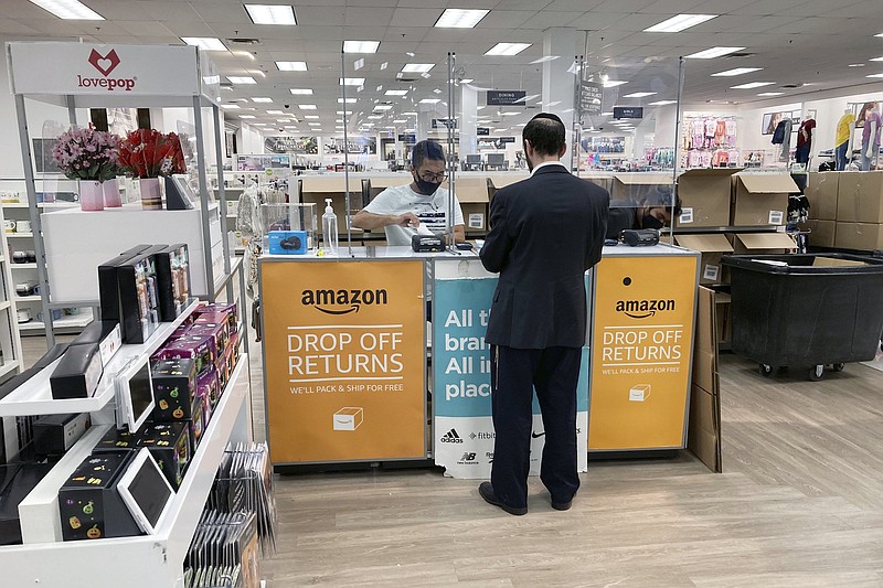 People return items they bought online in person at an Amazon return counter inside a Kohl's department store in Clifton, New Jersey, on Friday, September 3, 2021. (AP Photo/Ted Shaffrey)