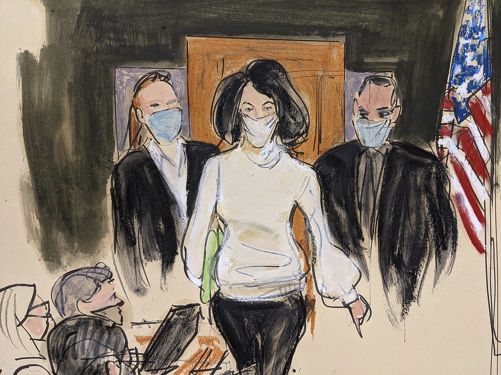 In this courtroom sketch, Ghislaine Maxwell enters the courtroom escorted by U.S. Marshalls at the start of her trial, Monday, Nov. 29, 2021, in New York. Two years after Jeffrey Epstein&#x27;s suicide behind bars, a jury is set to be picked Monday in New York City to determine a central question in the long-running sex trafficking case: Was his longtime companion, Ghislaine Maxwell, Epstein&#x27;s puppet or accomplice? (AP Photo/Elizabeth Williams)