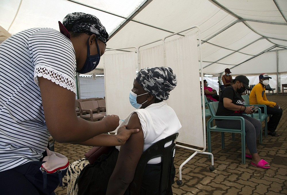 A woman receives a dose of a COVID-19 vaccine at a center, in Soweto, South Africa, Monday, Nov. 29, 2021. The emergence of the new omicron variant and the world&amp;#x2019;s desperate and likely futile attempts to keep it at bay are reminders of what scientists have warned for months: The coronavirus will thrive as long as vast parts of the world lack vaccines.  (AP Photo/Denis Farrell)