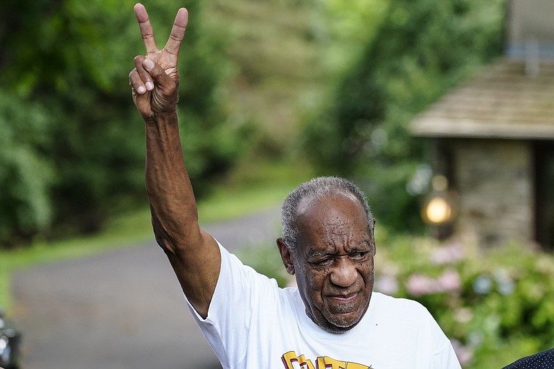 FILE - This June 30, 2021, file photo shows Bill Cosby gesturing outside his home in Elkins Park, Pa., after being released from prison. Prosecutors asked the U.S. Supreme Court to review the decision that overturned Cosby&#x2019;s conviction. In a petition filed Monday, Nov. 29, 2021 they wrote that courts should not equate a supposed promise made by a former prosecutor to lifetime immunity. (AP Photo/Matt Rourke, File)