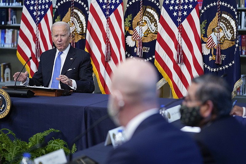 President Joe Biden speaks during a meeting with business leaders about the holiday shopping season, in the library of the Eisenhower Executive Office Building on the White House campus, Monday, Nov. 29, 2021, in Washington, as Josh Silverman, CEO of Etsy, center, and Carlos Castro, CEO of Todos Supermarket, listen. (AP Photo/Evan Vucci)