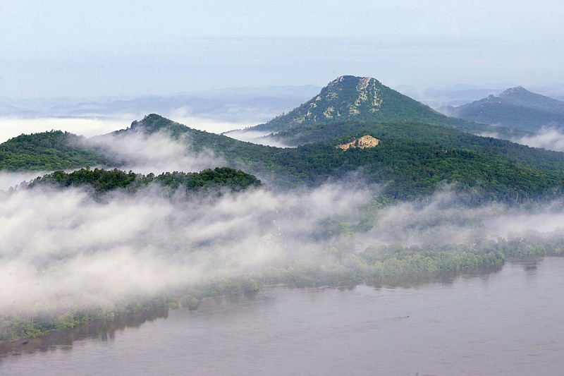 Morning fog begins to lift above Pinnacle Mountain State Park on the banks of the Arkansas River near Little Rock, May 29, 2015. (AP file photo/Danny Johnston)