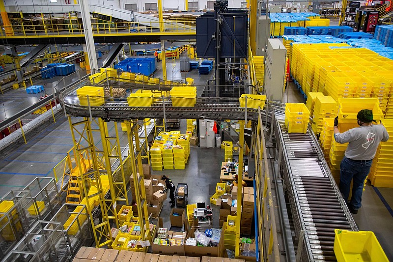 Bins move along a conveyor at an Amazon fulfillment center on Cyber Monday in Robbinsville, N.J. MUST CREDIT: Bloomberg photo by Michael Nagle.