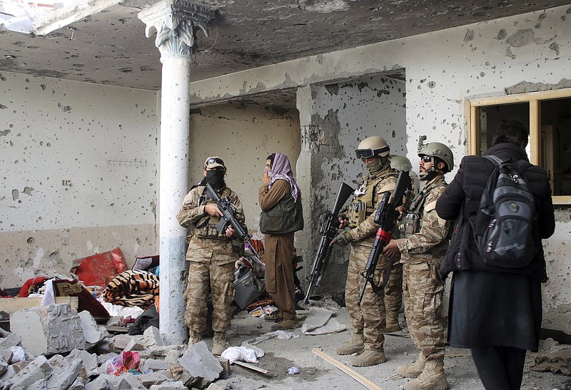 Taliban fighters inspect a house after an 8-hour gunbattle erupted between Taliban and Islamic State group fighters, when Taliban forces raided a suspected hideout of IS militants on the outskirts of Jalalabad, east of Kabul, Afghanistan, Tuesday, Nov. 30, 2021. Taliban fighters have summarily killed or forcibly ?disappeared? more than 100 former police and intelligence officers since taking power in Afghanistan, Human Rights Watch said in a report Tuesday. (AP Photo/Shir Shah Hamdard)