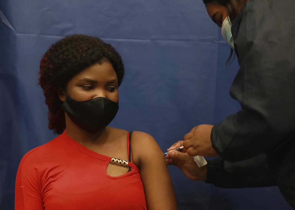 Beteko Ngona receives a dose of the Pfizer COVID-19 vaccine at the Vaccination Centre of Hope at the Cape Town International Convention Centre in Cape Town, South Africa, Tuesday, Nov. 30, 2021. (AP Photo/Nardus Engelbrecht)