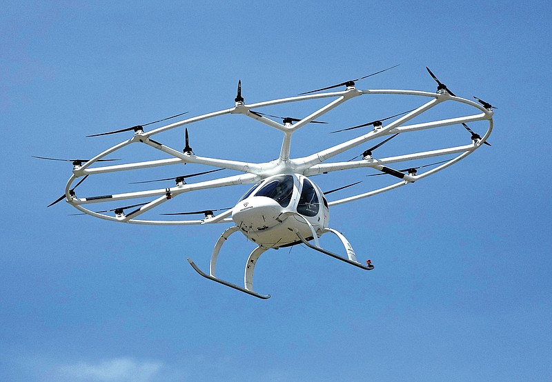 A urban air taxi prototype of a 2 seats, 18 rotors electric aircraft by German based company Volocopter makes a test flight during an event at the Air and Space Museum in Le Bourget, east of Paris, Monday, June 21, 2020. (AP Photo/Michel Euler)