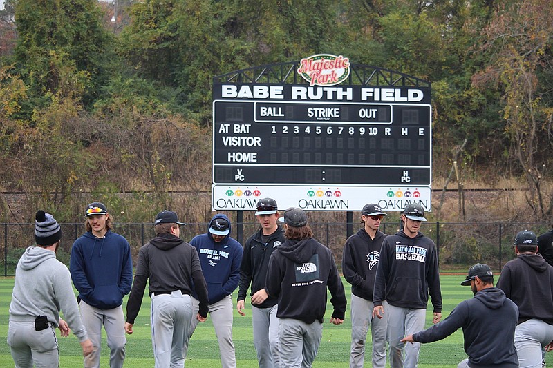 The National Park College baseball team warms up before its first ever practice on Majestic Park's Babe Ruth Field Wednesday morning. - Photo by Krishnan Collins of The Sentinel-Record