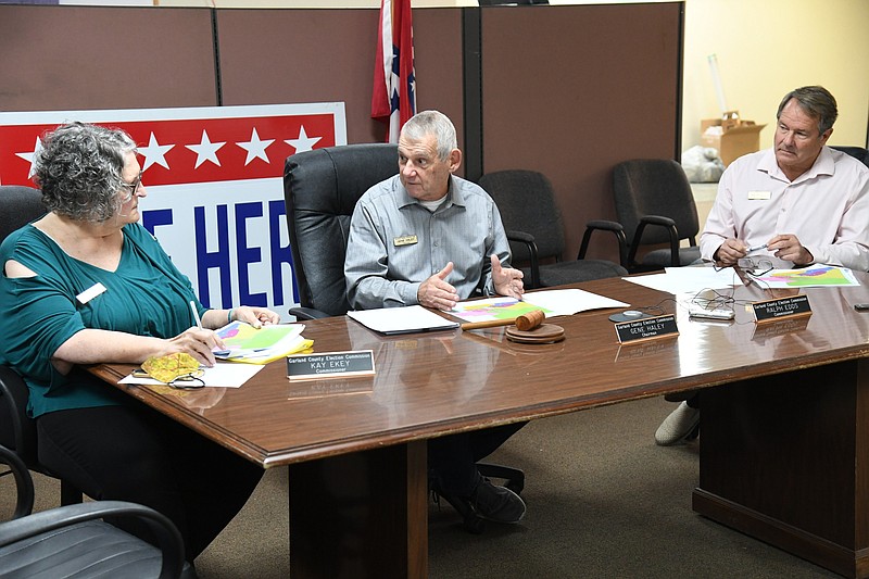 From left, Garland County Election Commissioner Kay Ekey, Commission Chairman/Election Coordinator Gene Haley and Commissioner Ralph Edds discuss elections scheduled for Feb. 8 Wednesday at the election commission building. - Photo by Tanner Newton of The Sentinel-Record