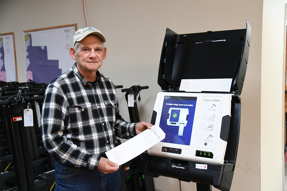 Garland County Election Commission Chairman/Election Coordinator Gene Haley shows the new program the county’s electronic ballot marking devices will run during next year’s elections Thursday at the election commission building. - Photo by Tanner Newton of The Sentinel-Record