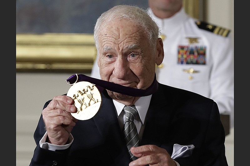 Actor, comedian and writer Mel Brooks holds up the 2015 National Medal of Arts awarded to him by President Barack Obama during a ceremony at the White House in 2016. Brooks released a memoir, “All About Me!: My Remarkable Life in Show Business.” (AP file/Carolyn Kaster)