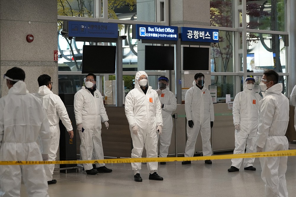 Quarantine officers wait to guide travelers at the arrival hall of the Incheon International Airport In Incheon, South Korea, Wednesday, Dec. 1, 2021. South Korea&#x27;s daily jump in coronavirus infections exceeded 5,000 for the first time since the start of the pandemic, as a delta-driven surge also pushed hospitalizations and deaths to record highs. (AP Photo/Ahn Young-joon)