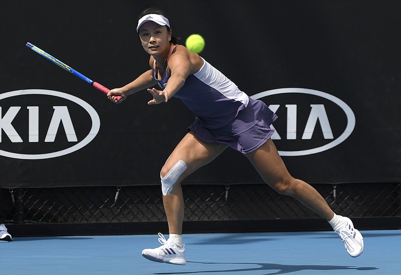 FILE - China's Peng Shuai makes a forehand return to Japan's Nao Hibino during their first round singles match at the Australian Open tennis championship in Melbourne, Australia, Tuesday, Jan. 21, 2020. The head of the women&#x2019;s professional tennis tour announced Wednesday, Dec. 1, 2021, that all WTA tournaments would be suspended in China because of concerns about the safety of Peng Shuai, a Grand Slam doubles champion who accused a former high-ranking government official in that country of sexual assault. (AP Photo/Andy Brownbill, File)