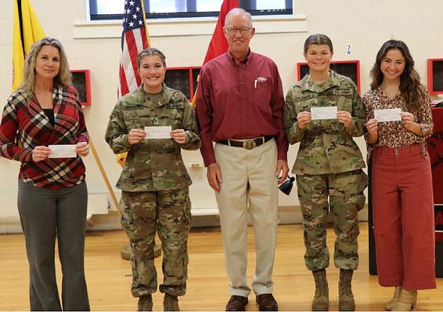 The Northwest Arkansas Military Officers Association of America chapter president Bob Crawford (center) presented $500 checks to Celeste Michaud (from left), Grace Coleman, Elizabeth Krusing and Tiffany Smith. The scholarships are awarded to military veterans or veteran family members attending the University of Arkansas.

(Courtesy Photo)