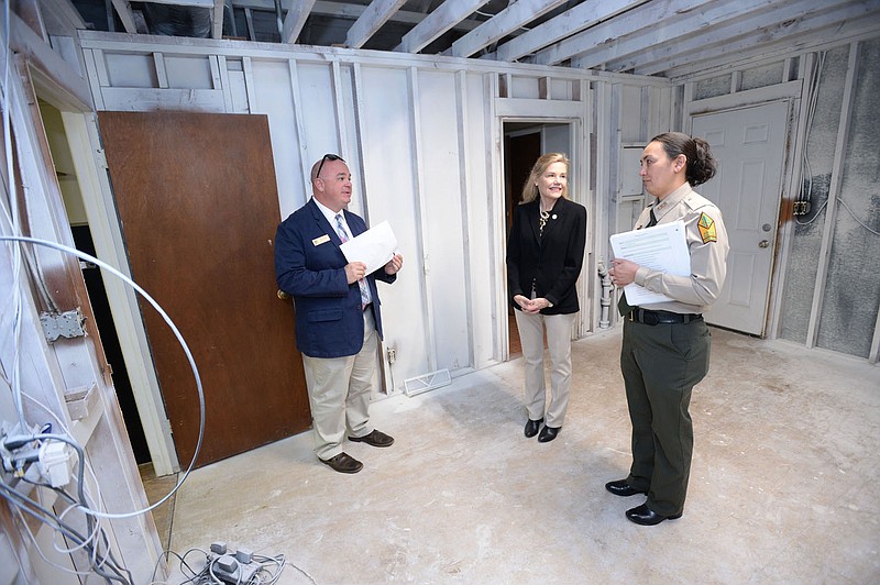 ANDY SHUPE NWA DEMOCRAT-GAZETTE Susan Donnangelo (from right), park superintendent at Prairie Grove Battlefield State Park, speaks Thursday, Dec. 2 with Stacy Hurst, secretary of the Arkansas Department of Parks, Heritage and Tourism, and Shea Lewis, deputy secretary, during a tour of the park's collection management facility. The state officials were at the park to discuss plans to improve the park's storage system and retain its artifacts on site.