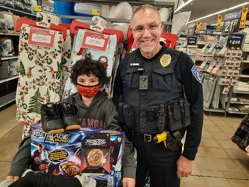 Justin Allen, left, with Hot Springs Police Cpl. Mike Brown, participate in the third annual Hot Springs Shop With A Cop event Sunday at Walmart, 1601 Albert Pike Road. - Photo by Brad Parker of The Sentinel-Record