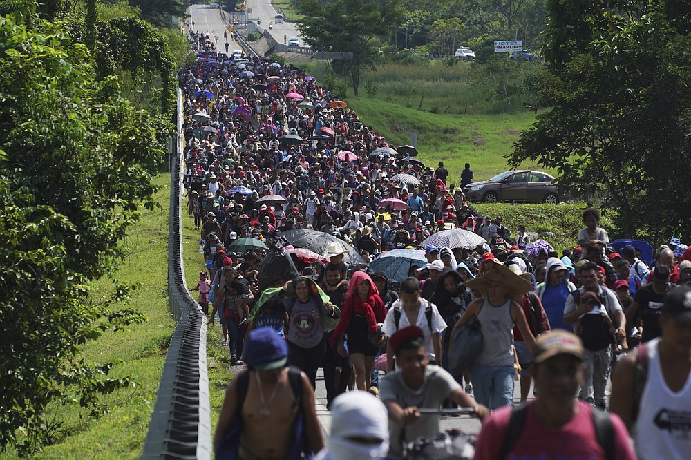 FILE - Migrants arrive in Villa Comaltitlan, Chiapas state, Mexico, Oct. 27, 2021, as they continue their journey through Mexico to the U.S. border. The Biden administration struck agreement with Mexico to reinstate a Trump-era border policy next week that forces asylum-seekers to wait in Mexico for hearings in U.S. immigration court, U.S. officials said Thursday. (AP Photo/Marco Ugarte, File)