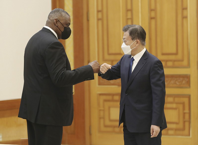 South Korean President Moon Jae-in, right, bumps elbows with U.S. Defense Secretary Lloyd Austin before their meeting at the presidential Blue House in Seoul, South Korea, Thursday, Dec. 2, 2021. Austin said Thursday that China's pursuit of hypersonic weapons &quot;increases tensions in the region&quot; and vowed the U.S. would maintain its capability to deter potential threats posed by China. (Ahn Jung-hwan/Yonhap via AP)