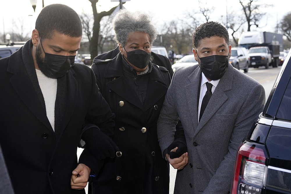 Actor Jussie Smollett, right, arrives with his mother Janet, Thursday, Dec. 2, 2021, at the Leighton Criminal Courthouse on day four of his trial in Chicago. Smollett is accused of lying to police when he reported he was the victim of a racist, anti-gay attack in downtown Chicago nearly three years ago. (AP Photo/Charles Rex Arbogast)