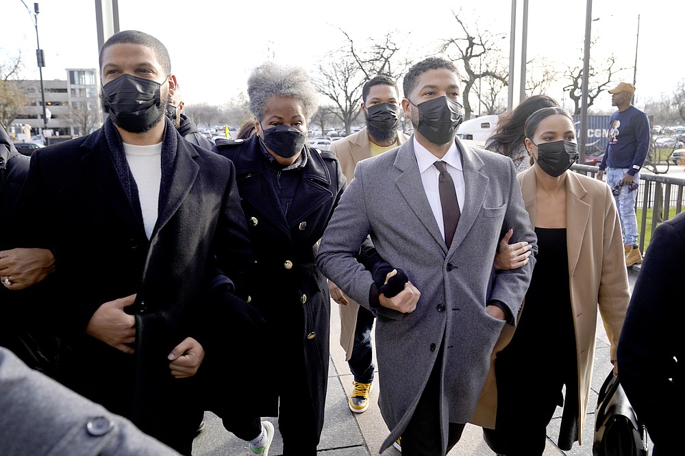 Actor Jussie Smollett, center, arrives with family Thursday, Dec. 2, 2021, at the Leighton Criminal Courthouse on day four of his trial in Chicago. Smollett is accused of lying to police when he reported he was the victim of a racist, anti-gay attack in downtown Chicago nearly three years ago. (AP Photo/Charles Rex Arbogast)