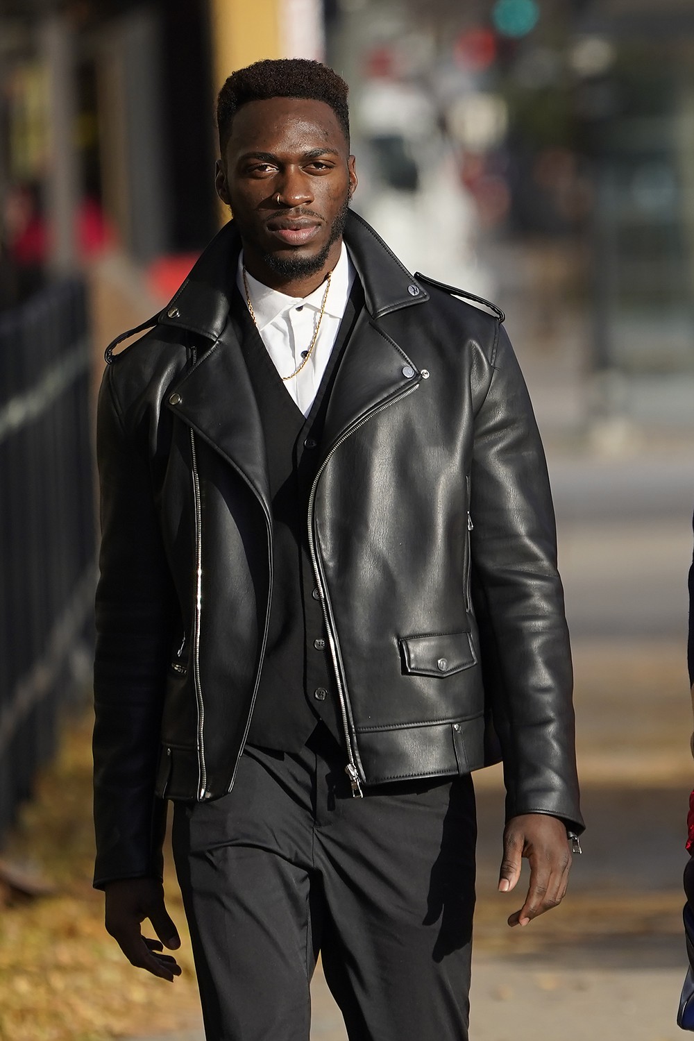 Abimbola Osundairo walks to the Leighton Criminal Courthouse to continue his testimony in the trial of actor Jussie Smollett Thursday, Dec. 2, 2021, in Chicago. Smollett is accused of lying to police when he reported he was the victim of a racist, anti-gay attack in downtown Chicago nearly three years ago. (AP Photo/Charles Rex Arbogast)