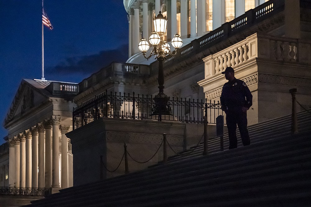 Night falls at the the Capitol in Washington, Thursday, Dec. 2, 2021, with the deadline to fund the government approaching. Republicans in the Senate are poised to stall a must-pass funding bill as they force a debate on rolling back the Biden administration's COVID-19 vaccine mandates for some workers. (AP Photo/J. Scott Applewhite)