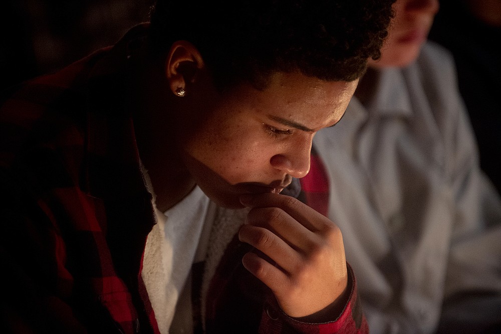Michael Roper, an Oxford High School sophomore, listens to prayers during a vigil after the Oxford High School school shootings, Tuesday, Nov. 30, 2021, at LakePoint Community Church in Oxford, Mich. (Jake May/The Flint Journal via AP)