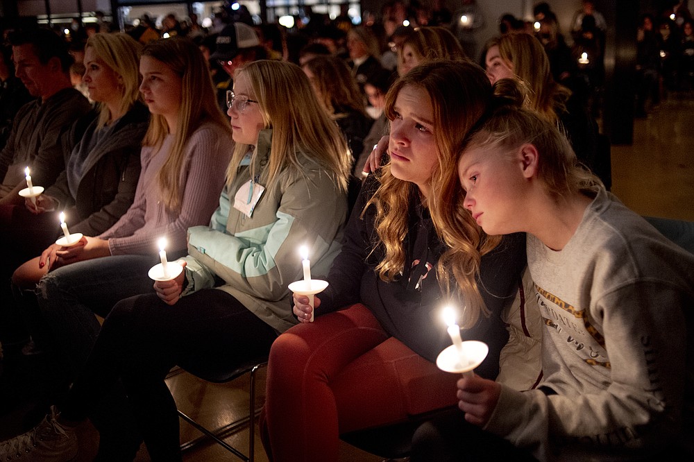 Emerson Miller, right, leans on her friend Joselyn&#x27;s shoulder as they listen to Jessi Holt, pastor at LakePoint Community Church, during a prayer vigil at the church after the Oxford High School school shooting, Tuesday, Nov. 30, 2021, in Oxford, Mich. (Jake May/The Flint Journal via AP)