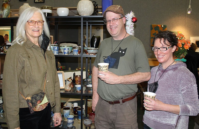 Sandy Young (from left) and artists Sam and Jenny Dowd visit at the Community Creative Center's Holiday Market VIP shopping preview Dec. 3 at the center in Fayetteville.
(NWA Democrat-Gazette/Carin Schoppmeyer)