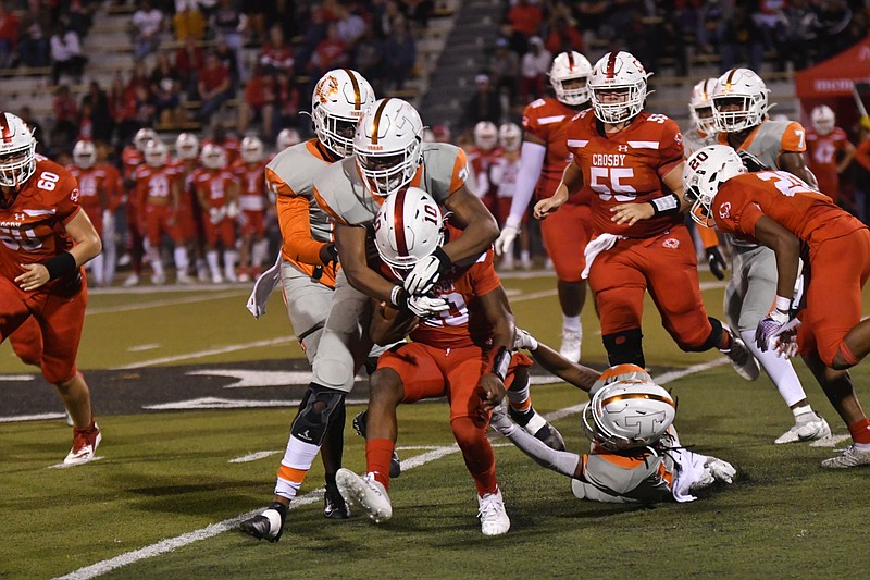 A pair of Texas High Tigers work to bring down a Crosby runner during their Class 5A, Division II Regional Championship game Friday, Dec. 3, 2021, at Abe Martin Stadium in Lufkin, Texas. (Photo by Kevin Sutton)