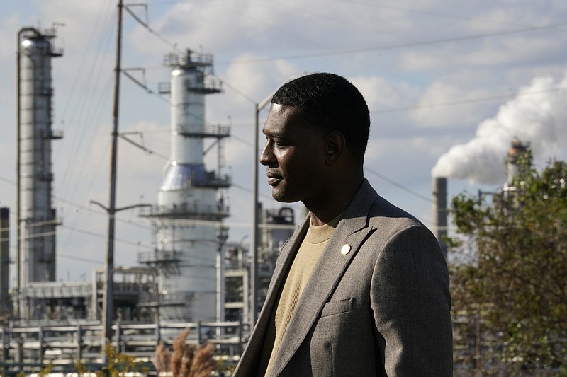 EPA Administrator Michael Regan stands near the Marathon Petroleum Refinery as he conducts a television interview, while touring neighborhoods that abut the refinery, in Reserve, La., Tuesday, Nov. 16, 2021. Regan visited St. John and St. James parishes on a tour he called &quot;Journey to Justice.&quot; The five-day trip from Mississippi to Texas in mid-November highlighted low-income, mostly minority communities adversely affected by decades of industrial pollution. (AP Photo/Gerald Herbert)