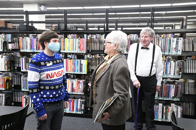 Paul Kagebein, Garland County Library’s adult services programmer, left, speaks with Millie Gore Lancaster as Phillip Wilson listens. A conversation between Kagebein and Lancaster a couple of months ago led to Lancaster and Wilson donating a combined $10,000 to the library to help get a bookmobile. - Photo by Tanner Newton of The Sentinel-Record