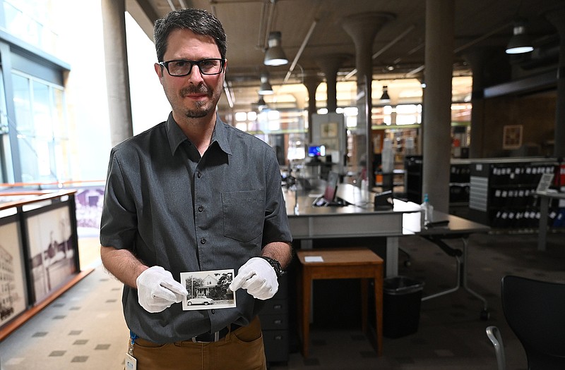 Brian K. Robertson, manager of the research services division of the Butler Center of Arkansas Studies, looks through historic photos he used for an online photo mapping project documenting downtown Little Rock and West Ninth Street circa 1960.

(Arkansas Democrat-Gazette/Stephen Swofford)