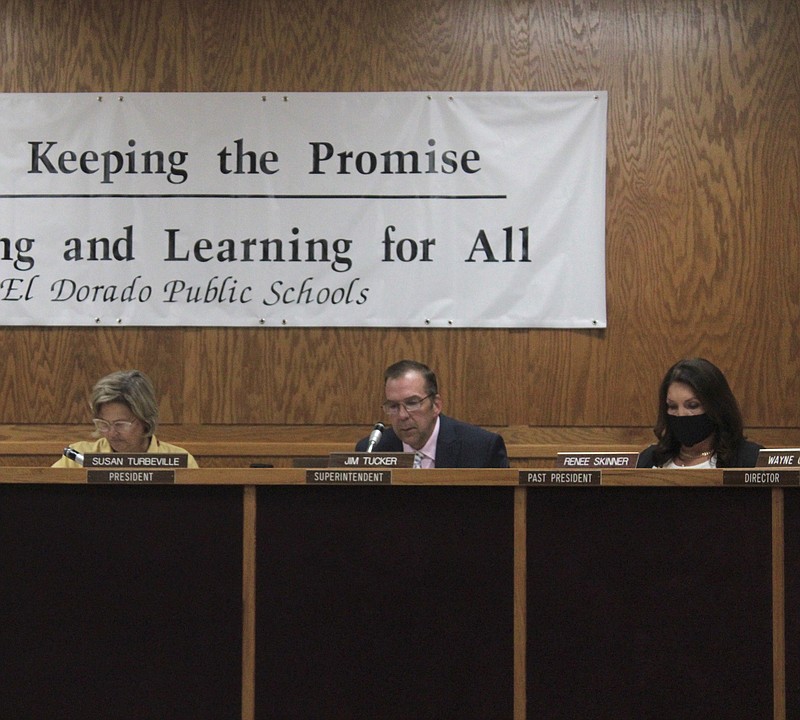 El Dorado School District Superintendent Jim Tucker speaks during an August school board meeting as President Susan Turbeville, left, and member Renee Skinner, right, listen. (News-Times file)