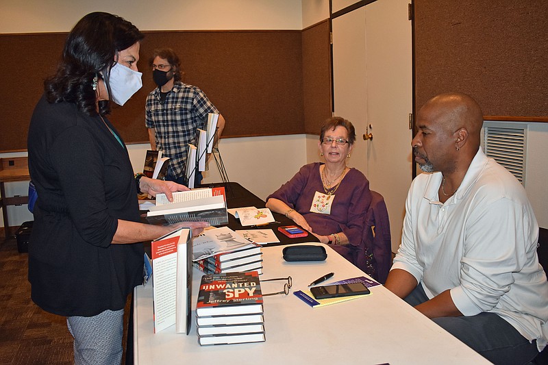 Gerry Tritz/News Tribune
At left, Alicia White chats with Jeffrey Sterling, author of &quot;Unwanted Spy,&quot; during Sunday's Local Author Showcase at Missouri River Regional Library.
