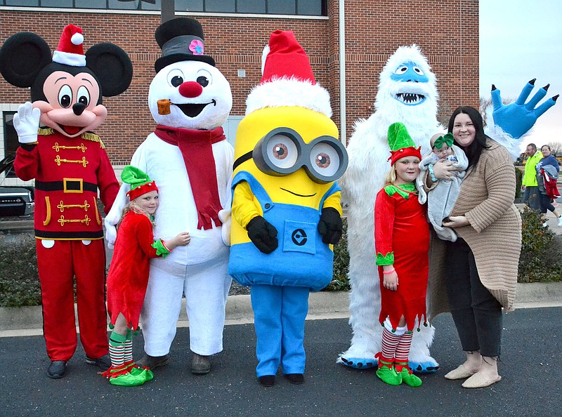 Oakley Lovell, 2 months, joined her mom, Maggie Lovell, and elves Hallie Keene, 7, and Hadlee Keene, 9, with Mickey Mouse (Rick Brouwer), Frosty the Snowman (Monte Keene), Minion (Dionne Brouwer) and the Abominable Snowman (Alex Lovell) in the annual Pea Ridge Christmas Parade.