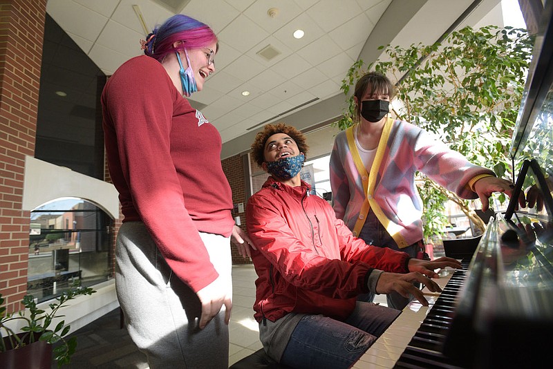 Lily King (from left), Adonis Wilson and Ray Brown, sophomore music education students at the University of Arkansas-Fort Smith, sing Thursday in the Smith-Pendergraft Campus Center in Fort Smith. The university announced this week a new diversity studies minor program. Go to nwaonline.com/211212Daily/ to see more photos.
(NWA Democrat-Gazette/Hank Layton)