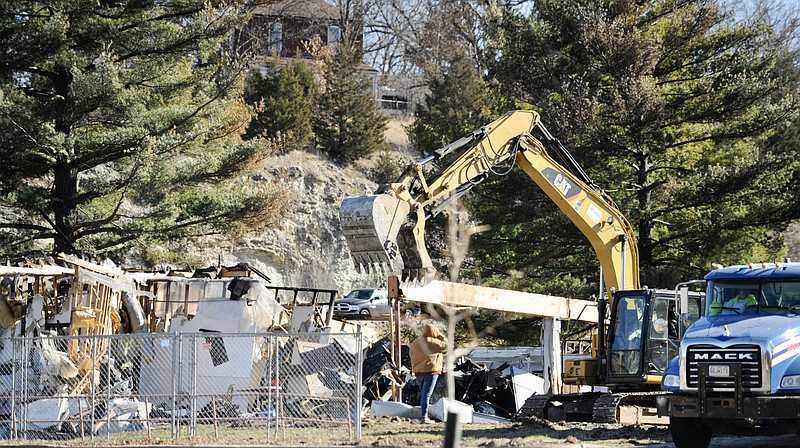 Crews began demolition Monday of the office building at 1621 E. Elm St., which housed Missouri Department of Social Services information technology before it burned on Nov. 2. (Joe Gamm/News Tribune)