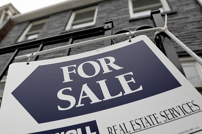 FILE - A sign is displayed outside a house for sale in Pittsburgh, Jan. 4, 2019. The Biden administration is looking to expand reporting requirements on all-cash real estate deals to help crack down on bad actors' use of the U.S. market to launder money made through illicit activity.  (AP Photo/Keith Srakocic, File)