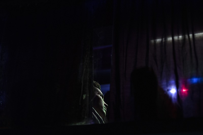 An Afghan man sits in a bus in Herat, Afghanistan, Tuesday , Nov. 23, 2021, for a 300-mile trip south to Nimrooz near the Iranian border. Afghans are streaming across the border into Iran, driven by desperation after the near collapse of their country's economy following the Taliban's takeover in mid-August. In the past three months, more than 300,000 people have crossed illegally into Iran, according to the Norwegian Refugee Council, and more are coming at the rate of 4,000 to 5,000 a day. (AP Photo/Petros Giannakouris)