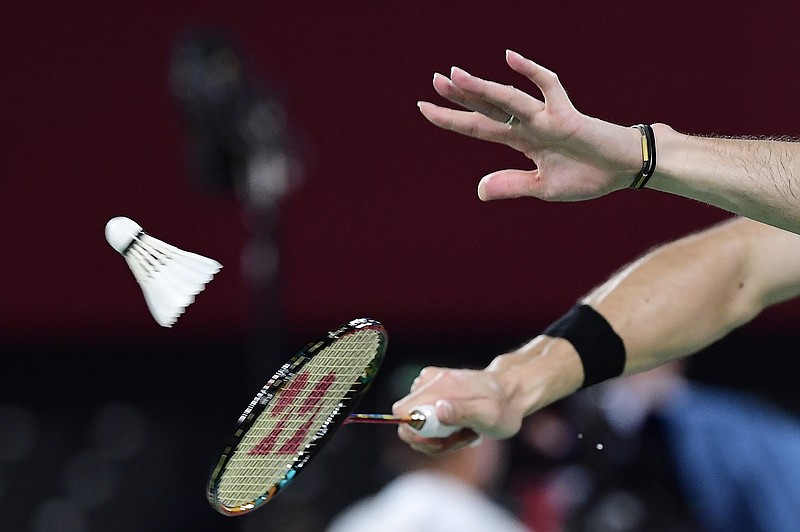 A badminton player hits a shot in the men's doubles badminton group stage match during the Tokyo 2020 Olympic Games at the Musashino Forest Sports Plaza in Tokyo on July 26, 2021. (PEDRO PARDO/AFP via Getty Images/TNS)