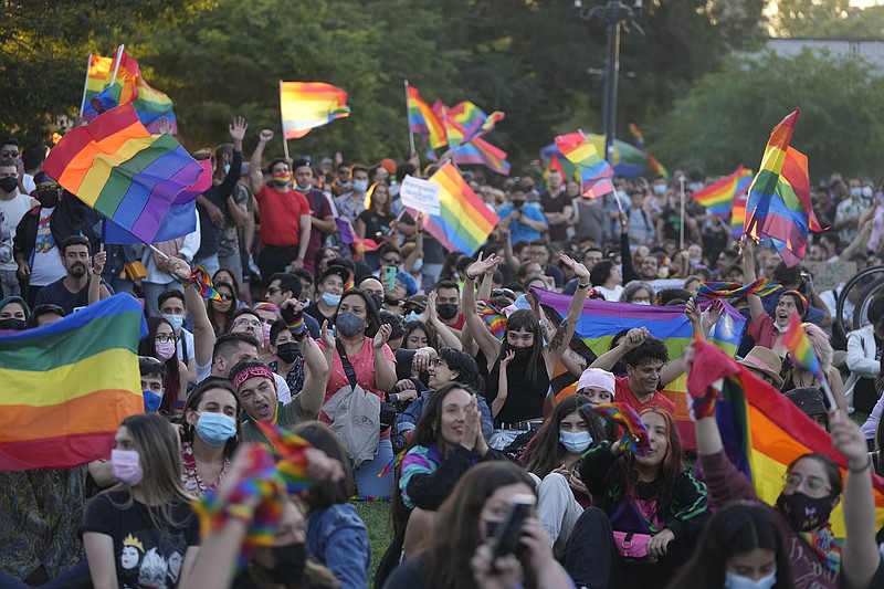 Members of the Movement for Homosexual Integration and Liberation celebrate after lawmakers approved legislation legalizing marriage and adoption by same-sex couples, in Santiago, Chile, Tuesday, Dec. 7, 2021. (AP/Esteban Felix)