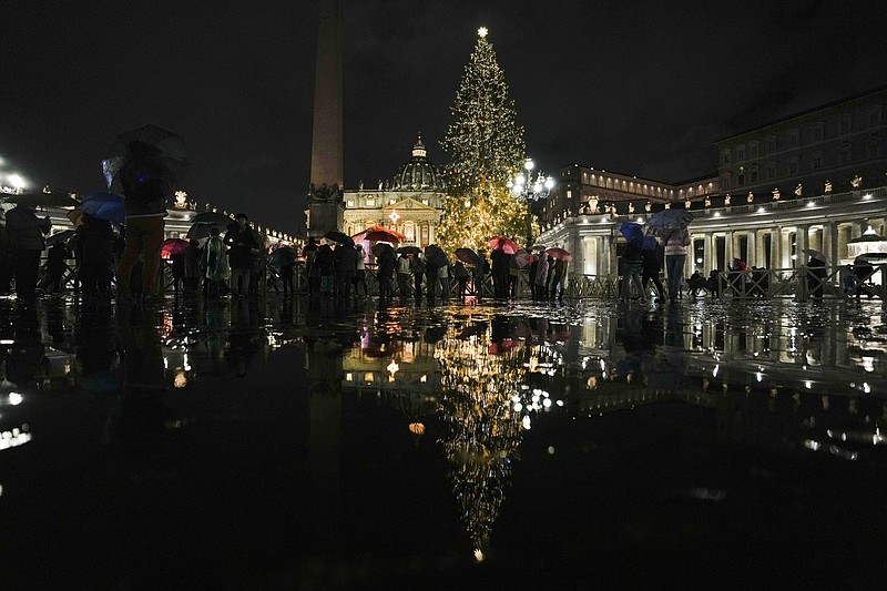 A view of the nativity scene and the Christmas tree that adorn St. Peter's square at the Vatican, during the lighting ceremony, Friday, Dec. 10, 2021. The nativity scene is from the Huancavelica region, in Peru, and the 113-year-old, 28-meter-tall tree, a gift from the city of Andalo in Trentino Alto Adige-South Tyrol region, northeastern Italy. (AP Photo/Alessandra Tarantino)